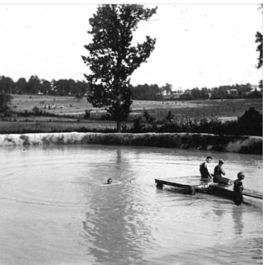 Historic photo of people swimming near a dock